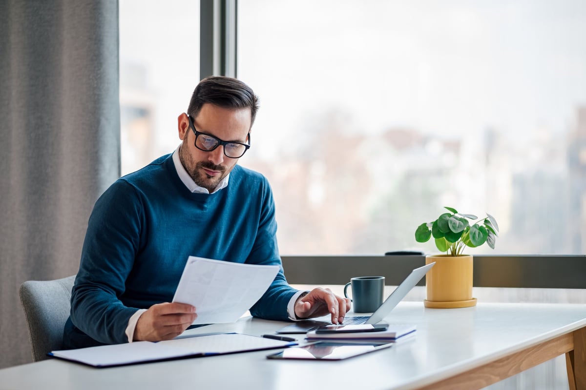 Busy elegant bearded adult company director, checking the company finances