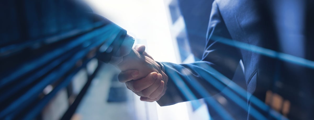 Businessmen making handshake with partner