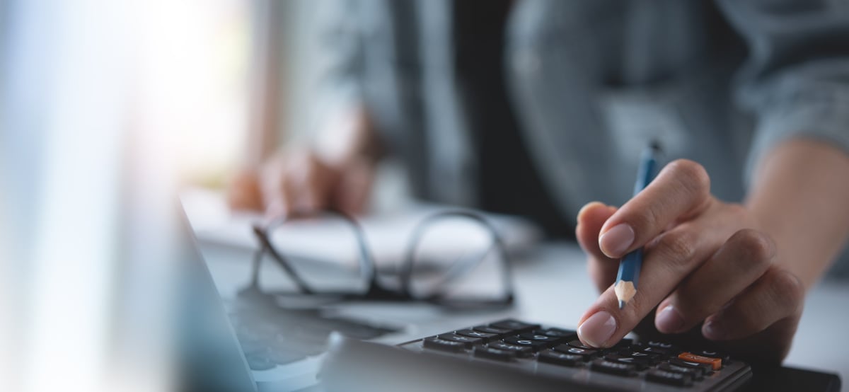 Woman hand using calculator to calculate home finance