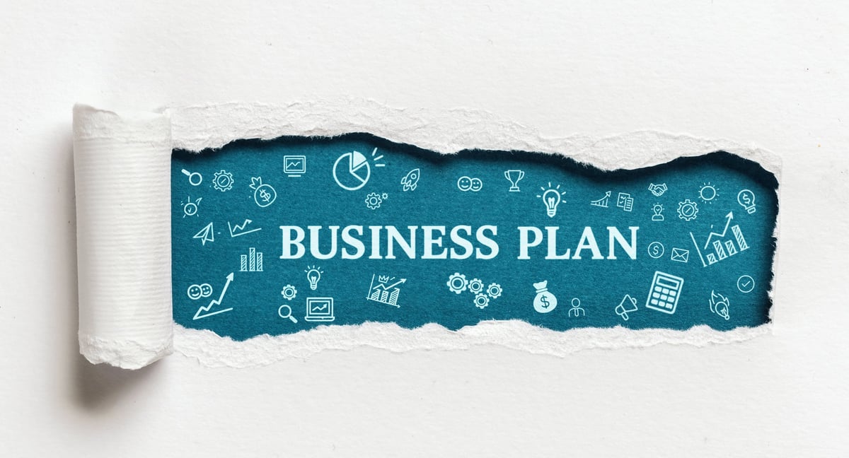 Blue torn paper with business plan text and icons for financial strategy development